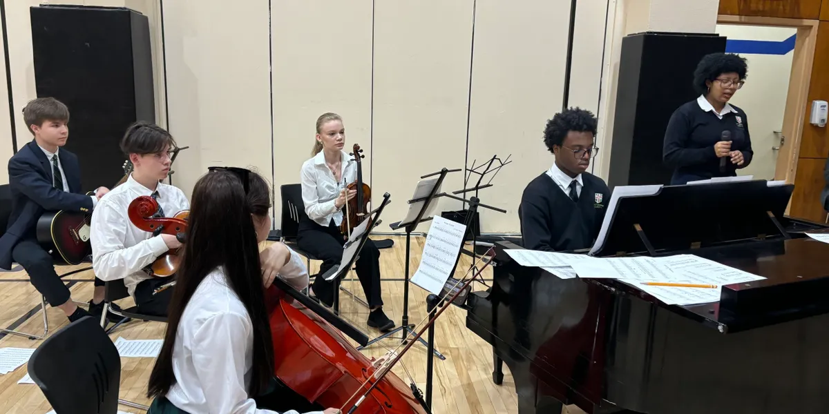 Students rehearsing in a school music room.