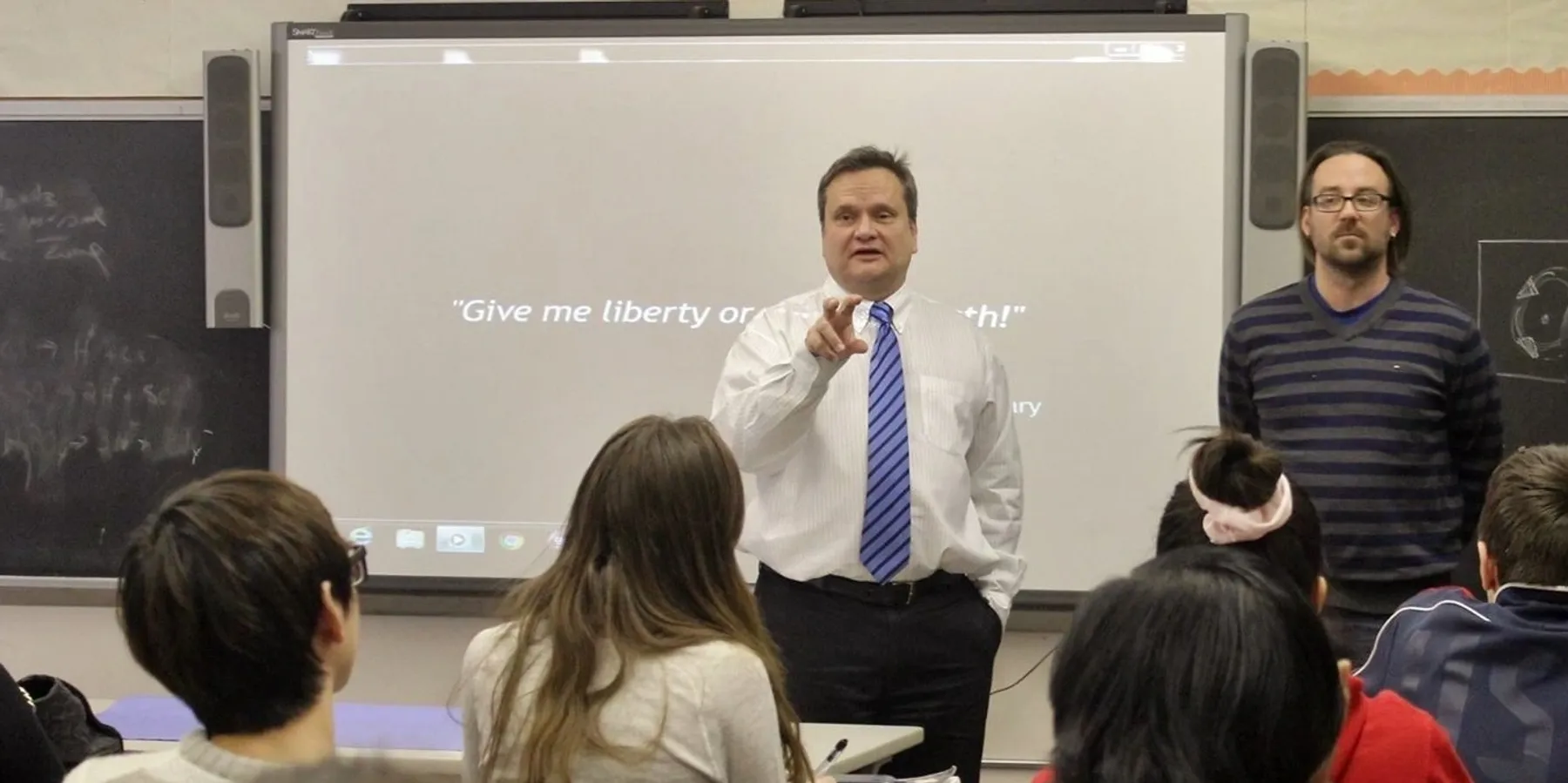 Classroom lecture with teacher and students.