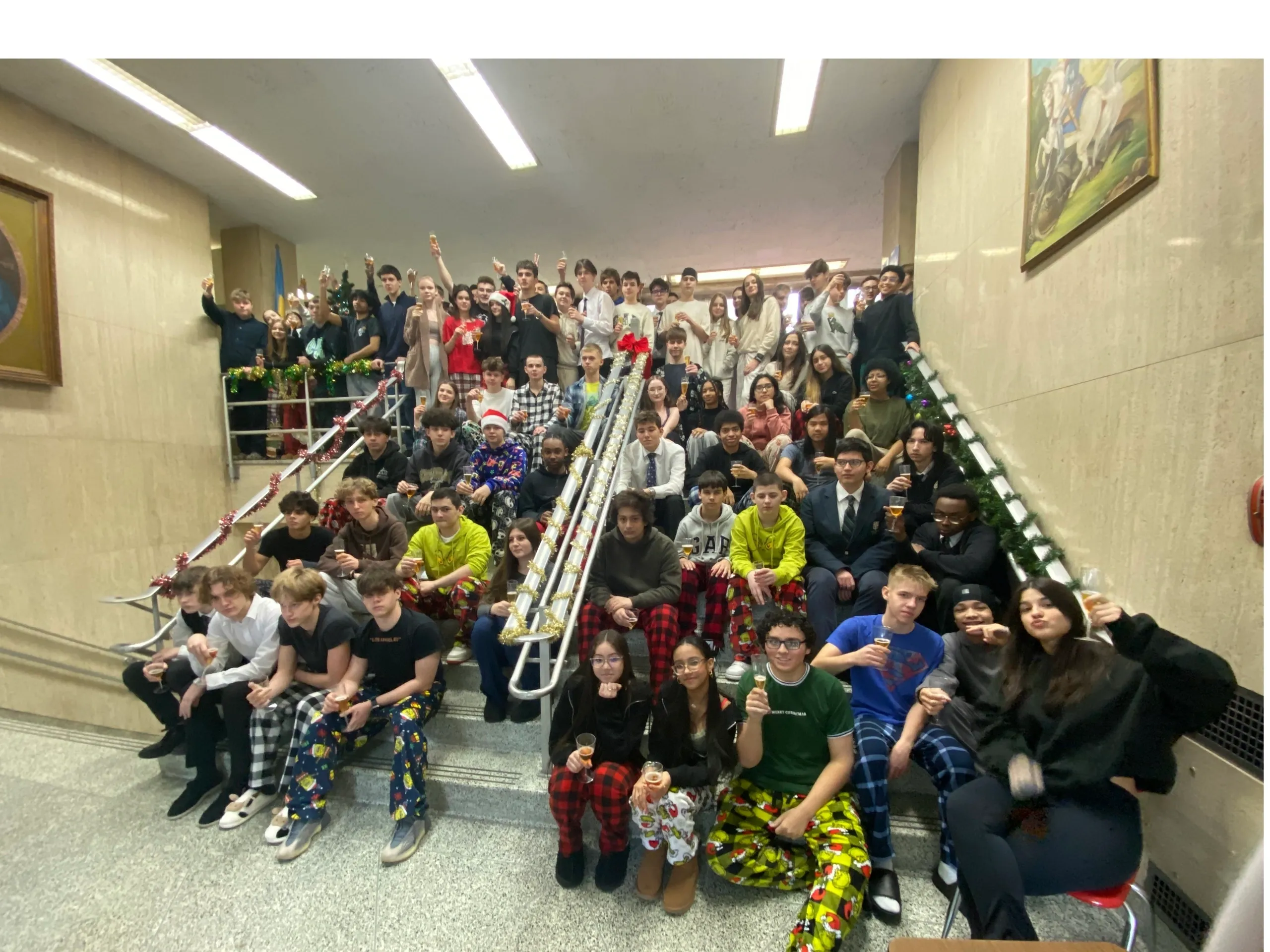 Large group of people on stairs, celebrating.