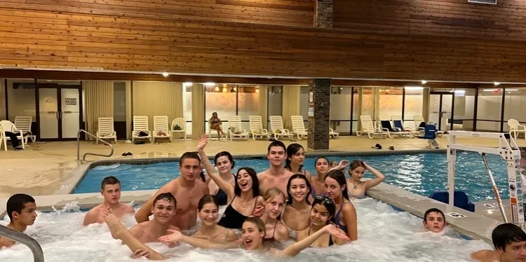 Group of people enjoying a hot tub.
