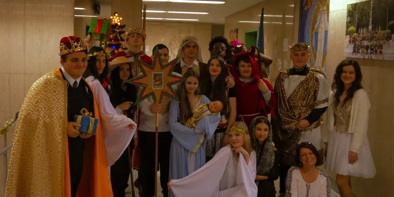 Group in festive costumes with decorations.