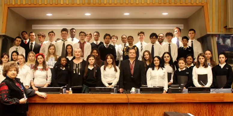 Group of people posing in formal attire.