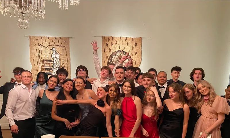 Group of people posing at a formal event.
